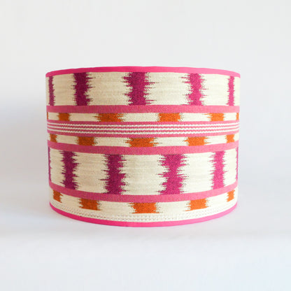 Front view of a lampshade with a pink, orange and white pattern and a pink rim