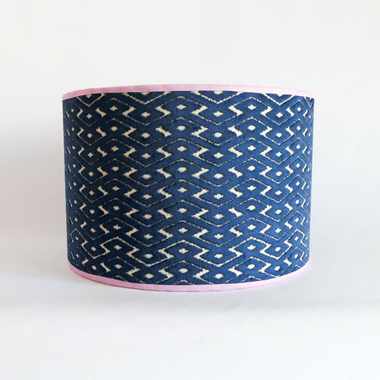 Front view of a blue patterned lampshade with a lila rim