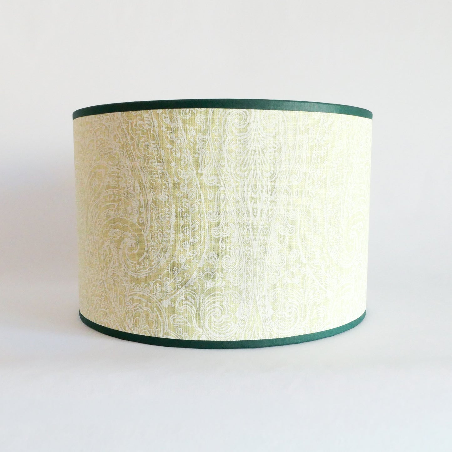 Front view of a lampshade with a light green pattern and a dark green rim